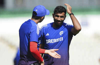 Shubman Gill and Jasprit Bumrah in discussion during a practice session.